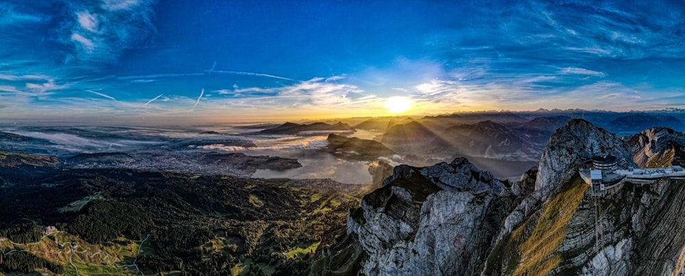 the sun is setting over a mountain range