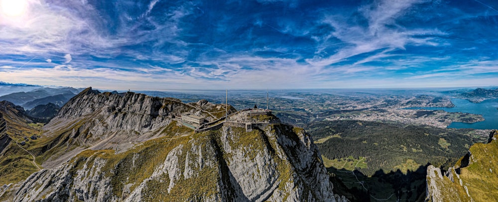 a scenic view of a mountain range with a lake in the distance