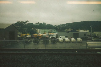 A fleet of VRC Express Inc trucks lined up outside the Bensenville headquarters on a bright day.