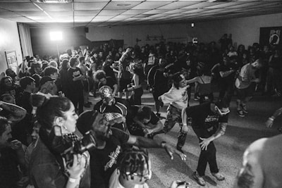 A dynamic crowd dancing passionately at a live music event.