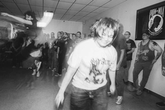 A vintage black-and-white photo of the club's first gathering in a cozy hall.
