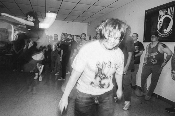 A vintage black-and-white photo of the club's first gathering in a cozy hall.