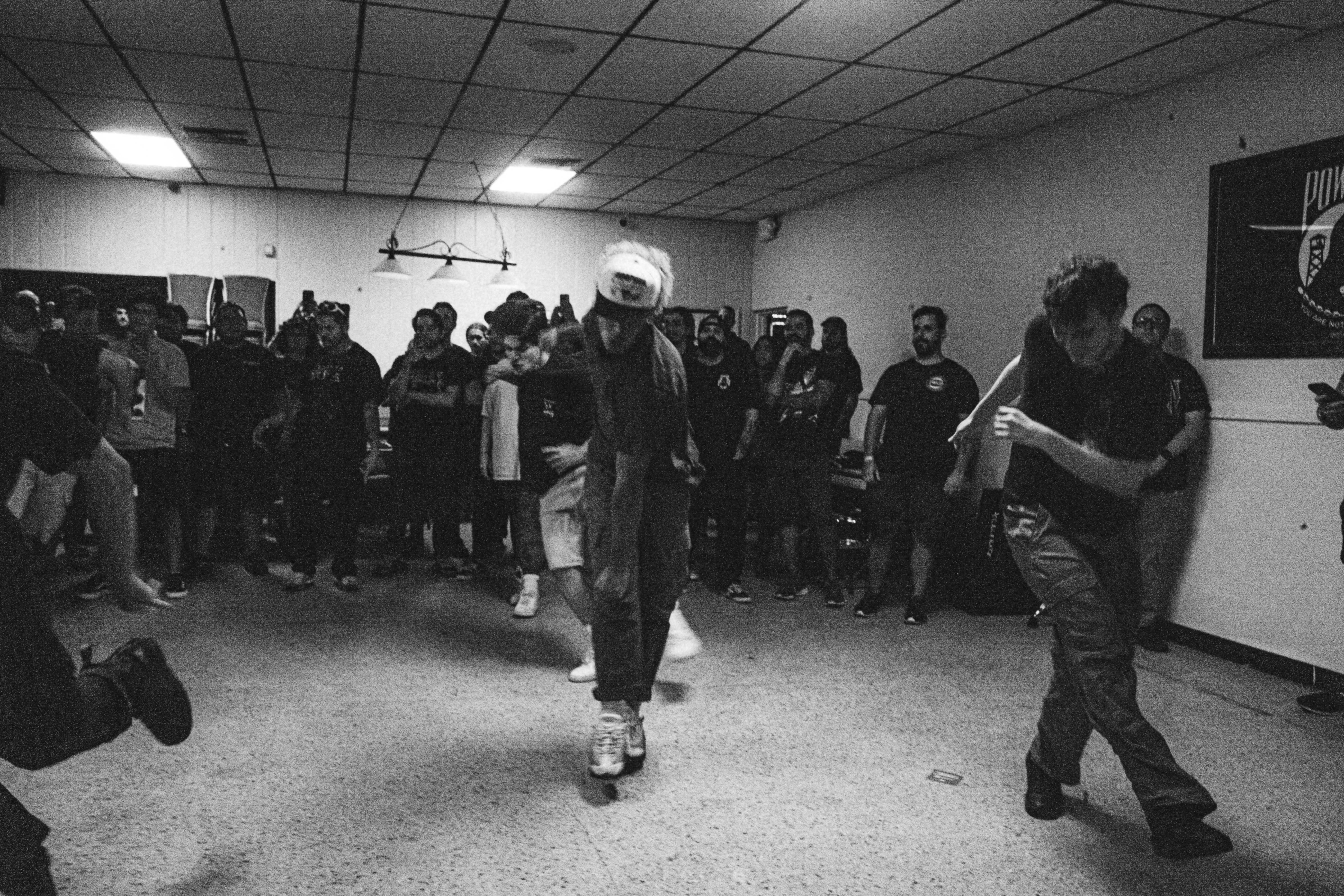 A group of people standing in a room photo – Free Man Image on Unsplash
