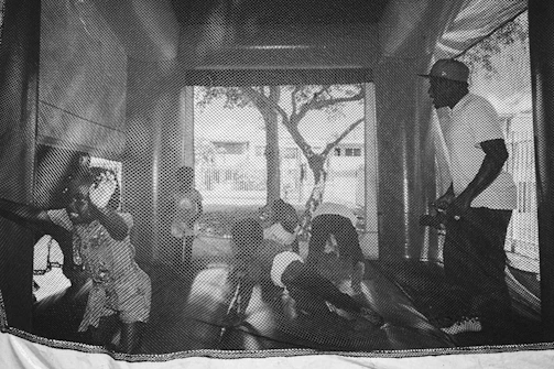 A cheerful image of children playing on a bounce house.