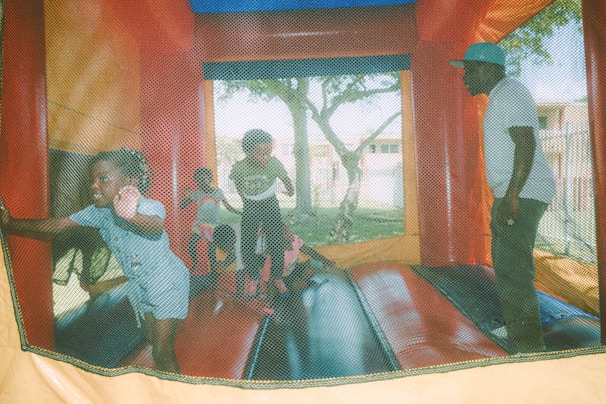 A vibrant bounce house set up at a sunny outdoor event.