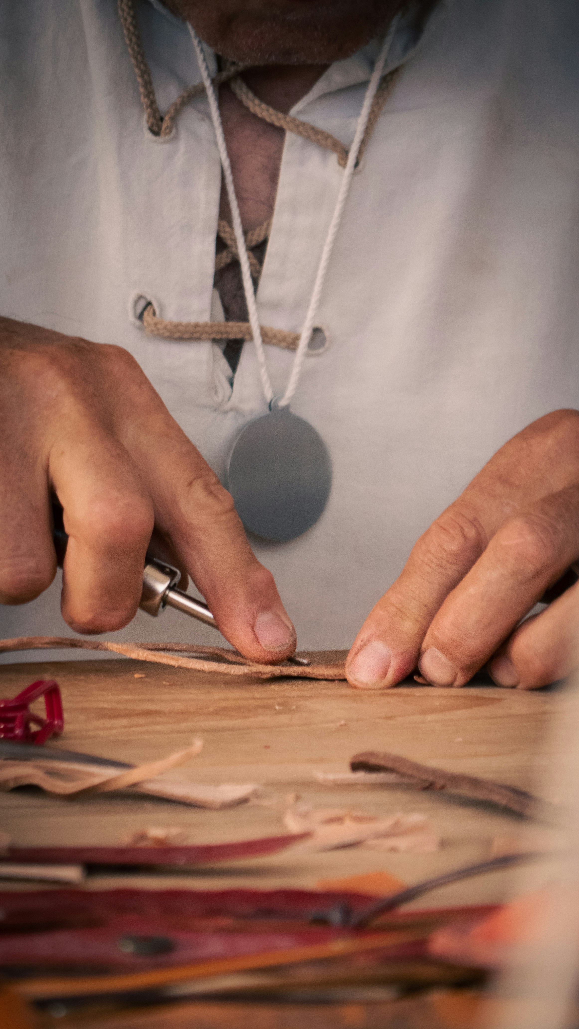 a man is working on a piece of wood