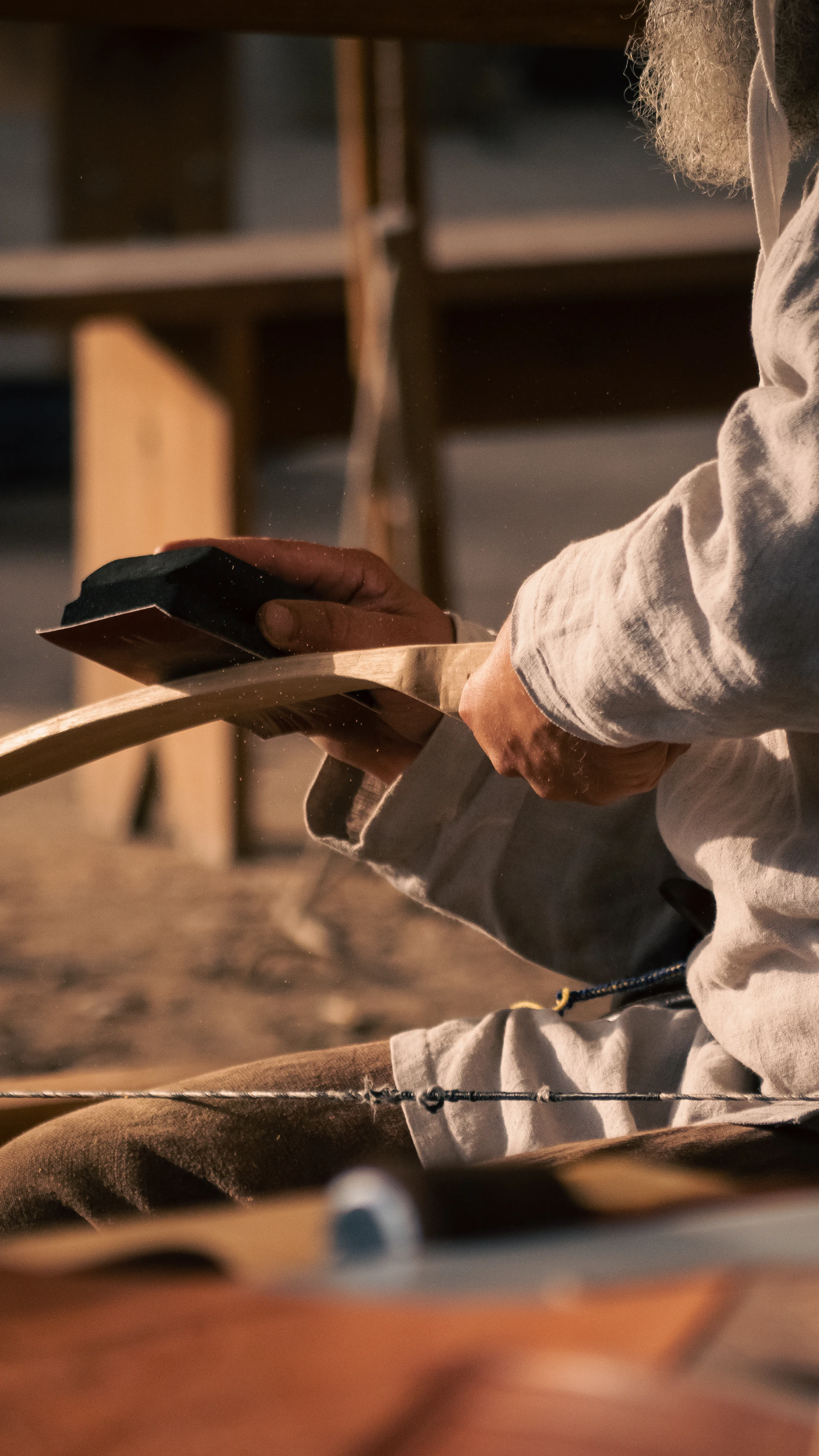 a man sitting on a bench with a remote control in his hand