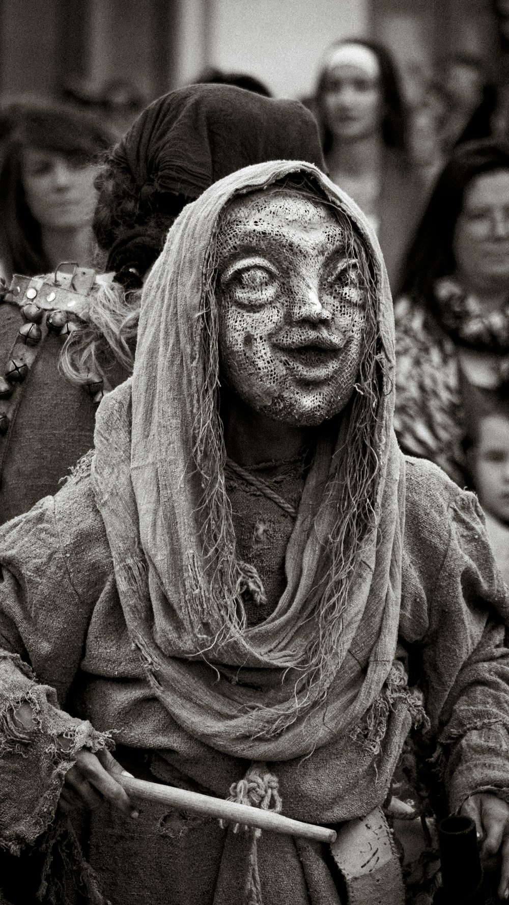 a group of people with painted faces and scarves