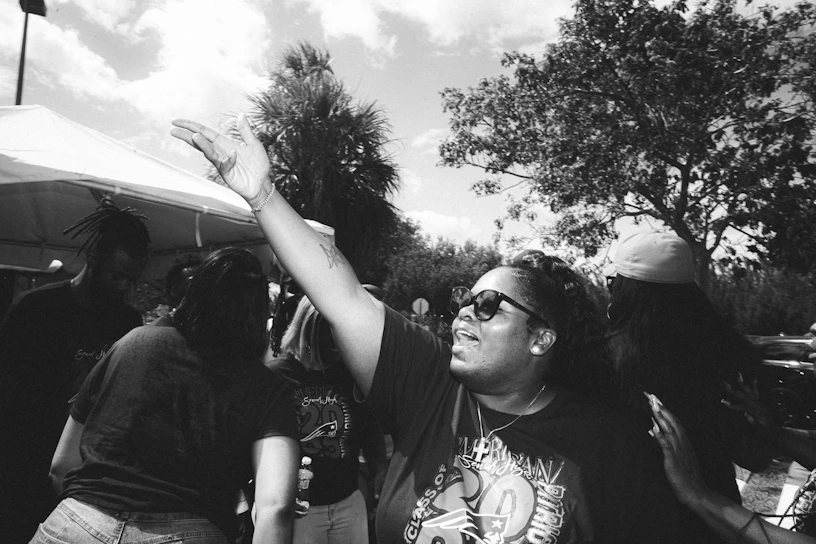 Volunteers warmly greeting and embracing community members at a local outreach event.