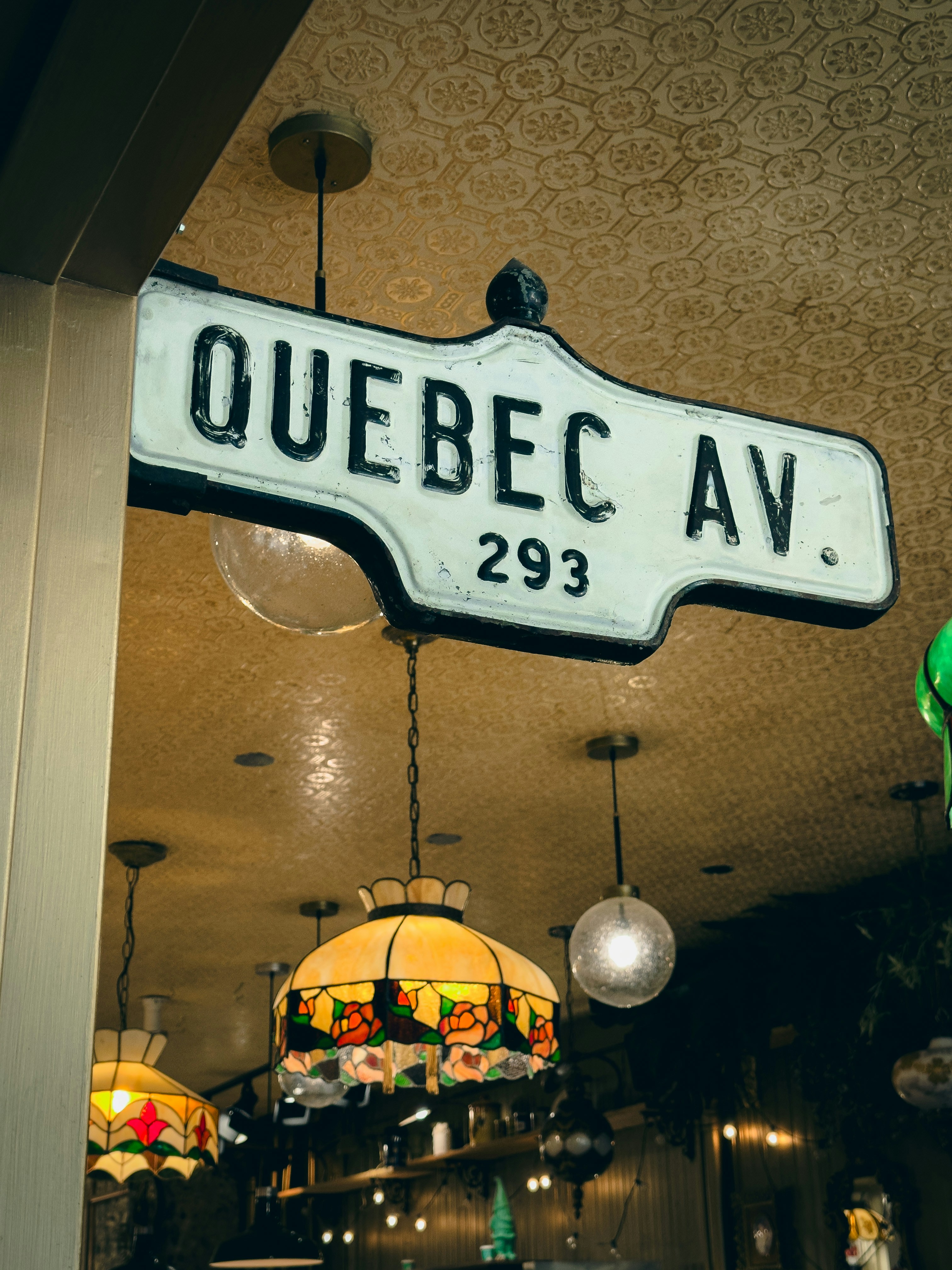 a sign hanging from the ceiling of a restaurant