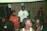 A group of diverse individuals engaged in a supportive discussion in a cozy setting.