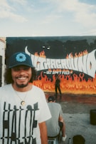 A smiling person wearing a custom t-shirt with a hand-drawn cartoon character.