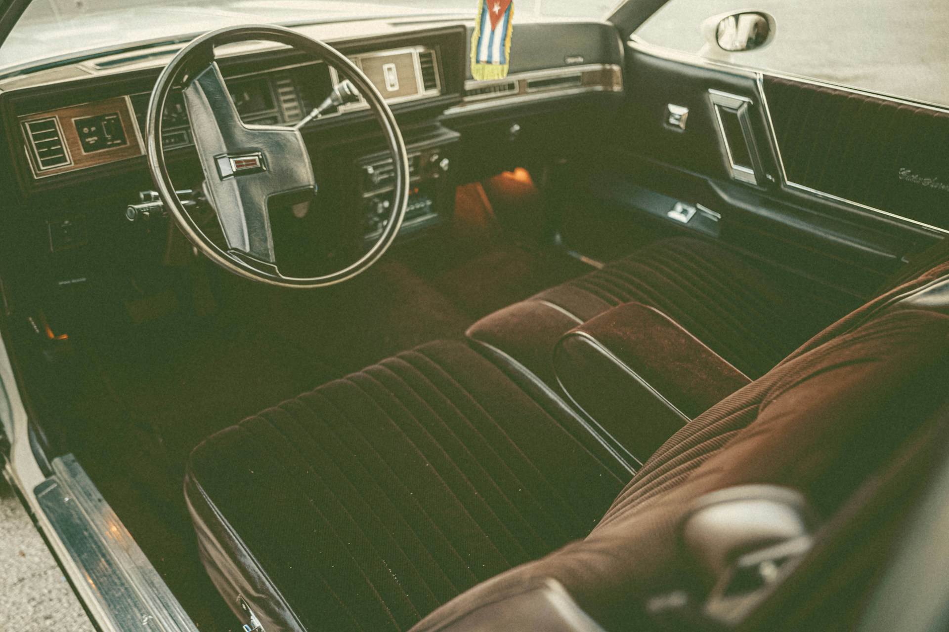 the interior of a car with leather seats and a steering wheel