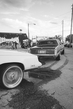 Photo of drivers standing beside their vehicles in the local area.