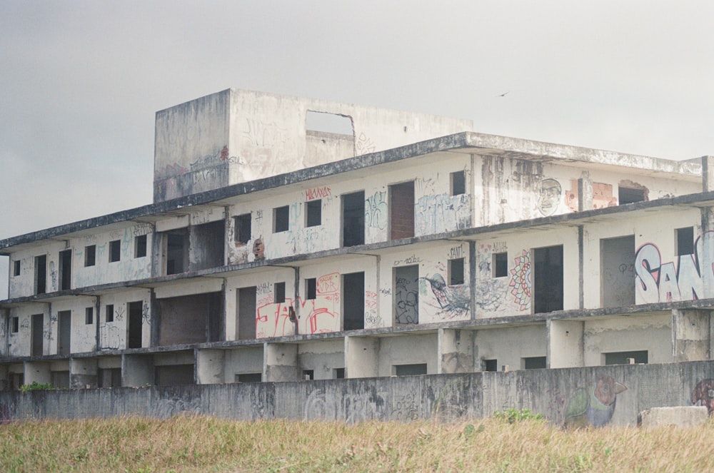 an abandoned building with graffiti on the windows