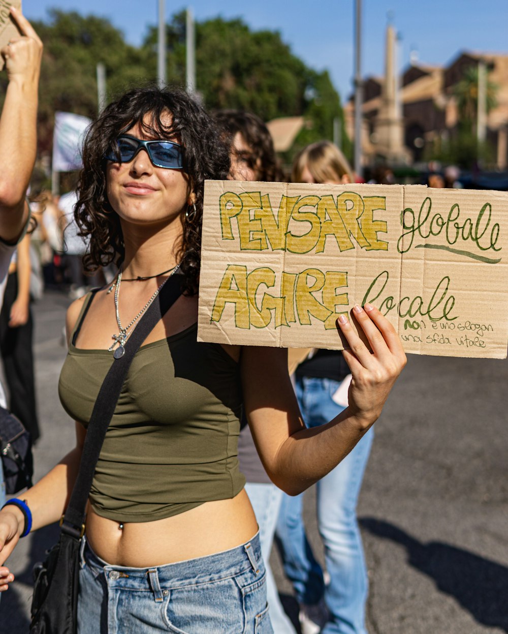 a woman holding a sign with words on it
