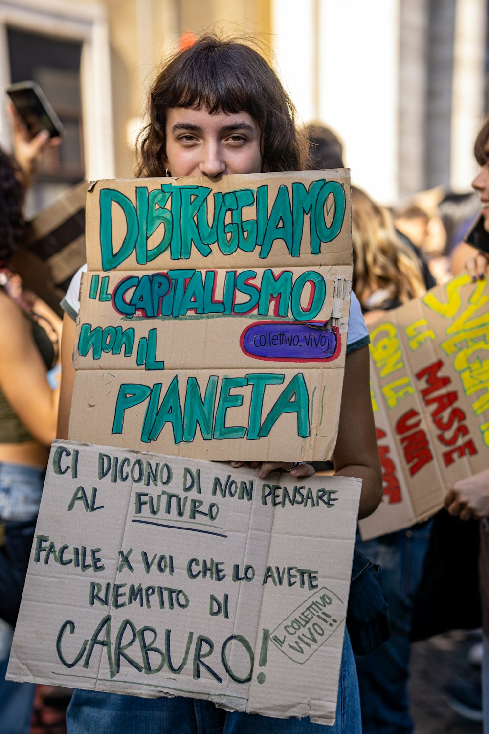 a person holding a sign in front of a crowd