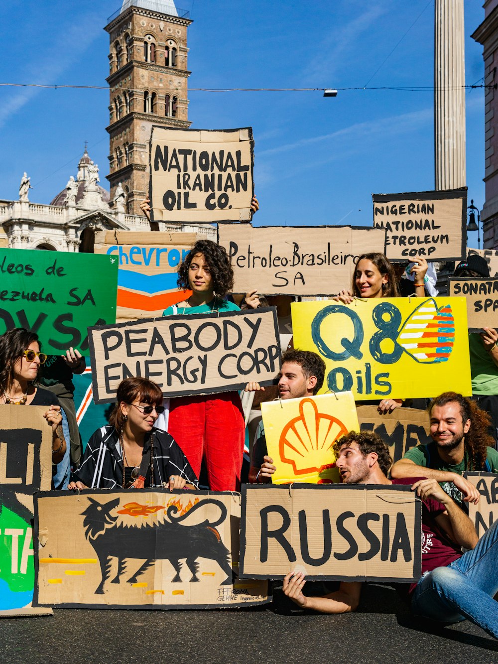 a group of people holding up signs in the street