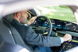 a man in a suit driving a car