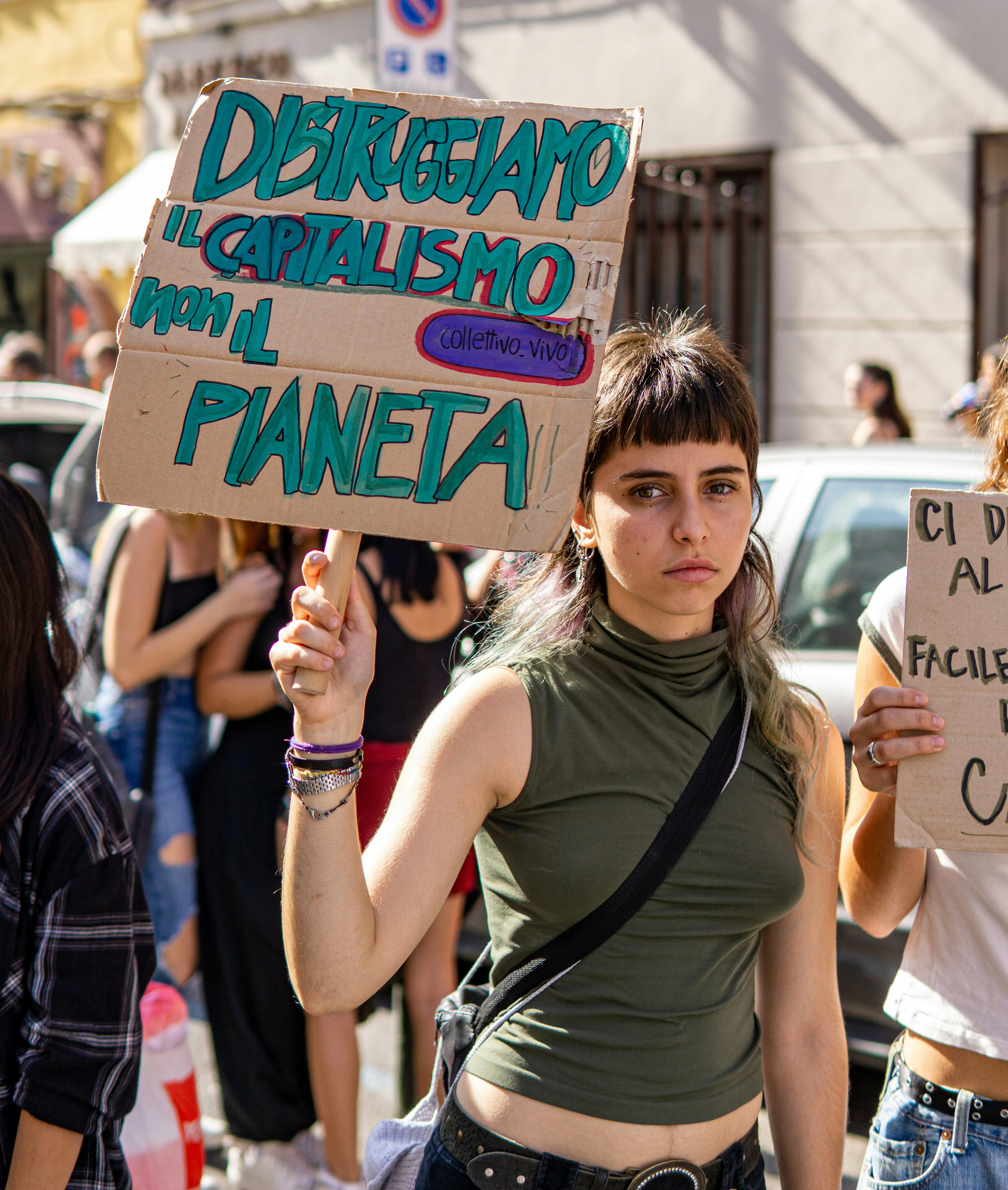 a woman holding a sign in a protest