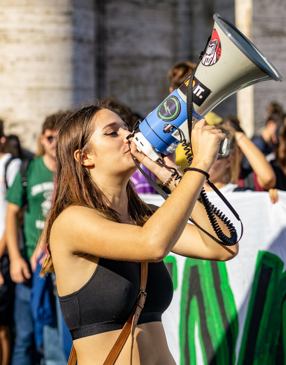 a woman holding a megaphone up to her face