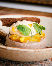 An elegant dessert plated beautifully with intricate decoration.