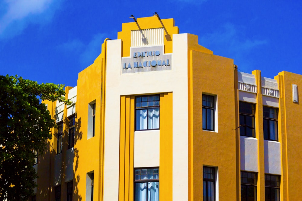 a yellow and white building with a clock on it