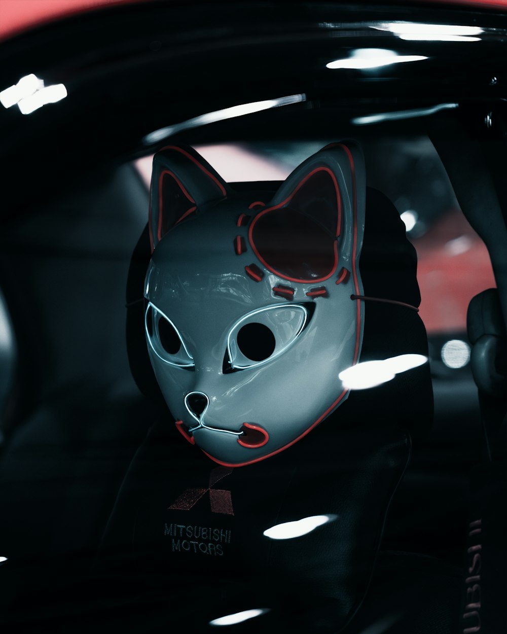 a cat mask sitting in the passenger seat of a car