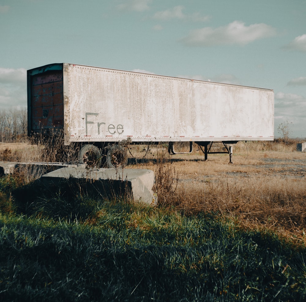 a large white box truck parked in a field