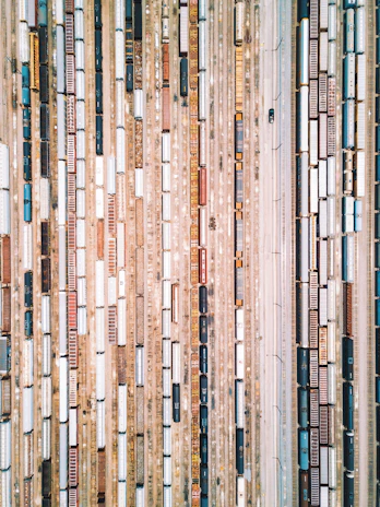 an aerial view of a train yard with many cars