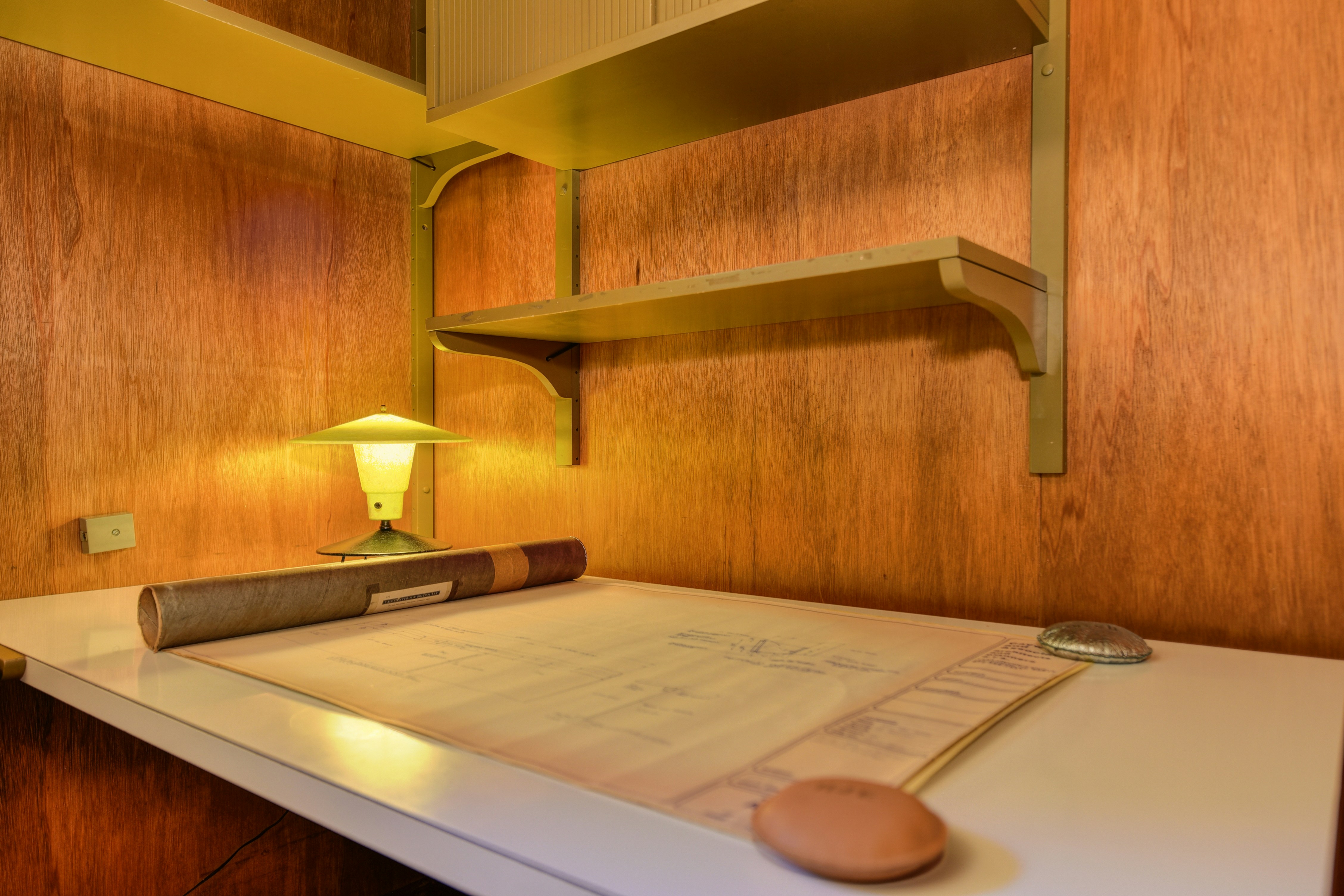 roll top desk - a desk with a lamp and a book on it