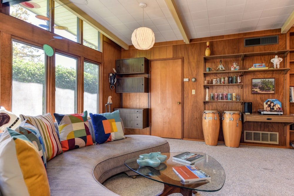 a living room filled with furniture and lots of windows