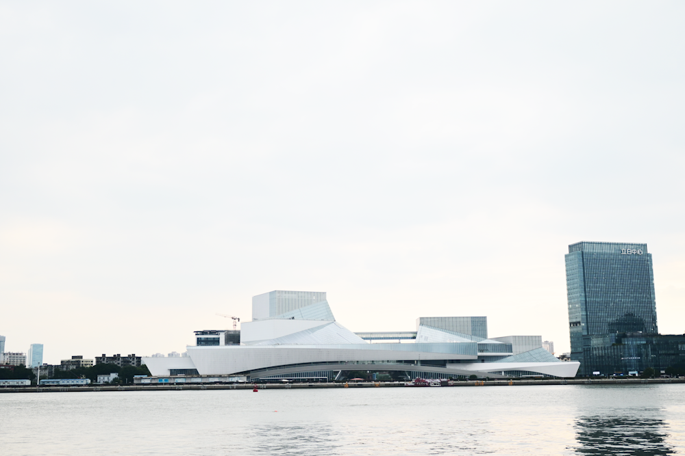 a body of water with buildings in the background