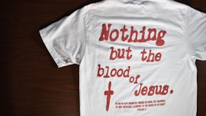 Close-up of a t-shirt with a bold Bible verse and patriotic colors
