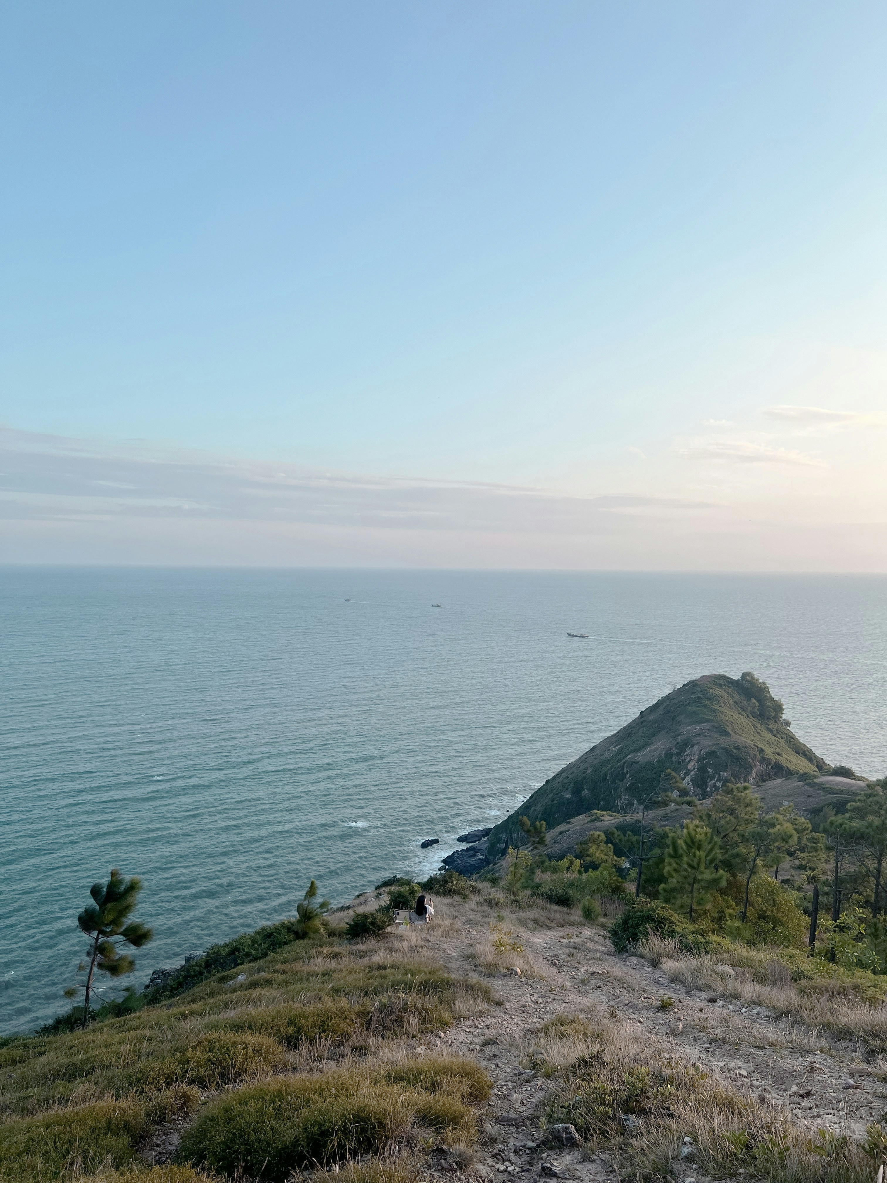 a view of the ocean from the top of a hill