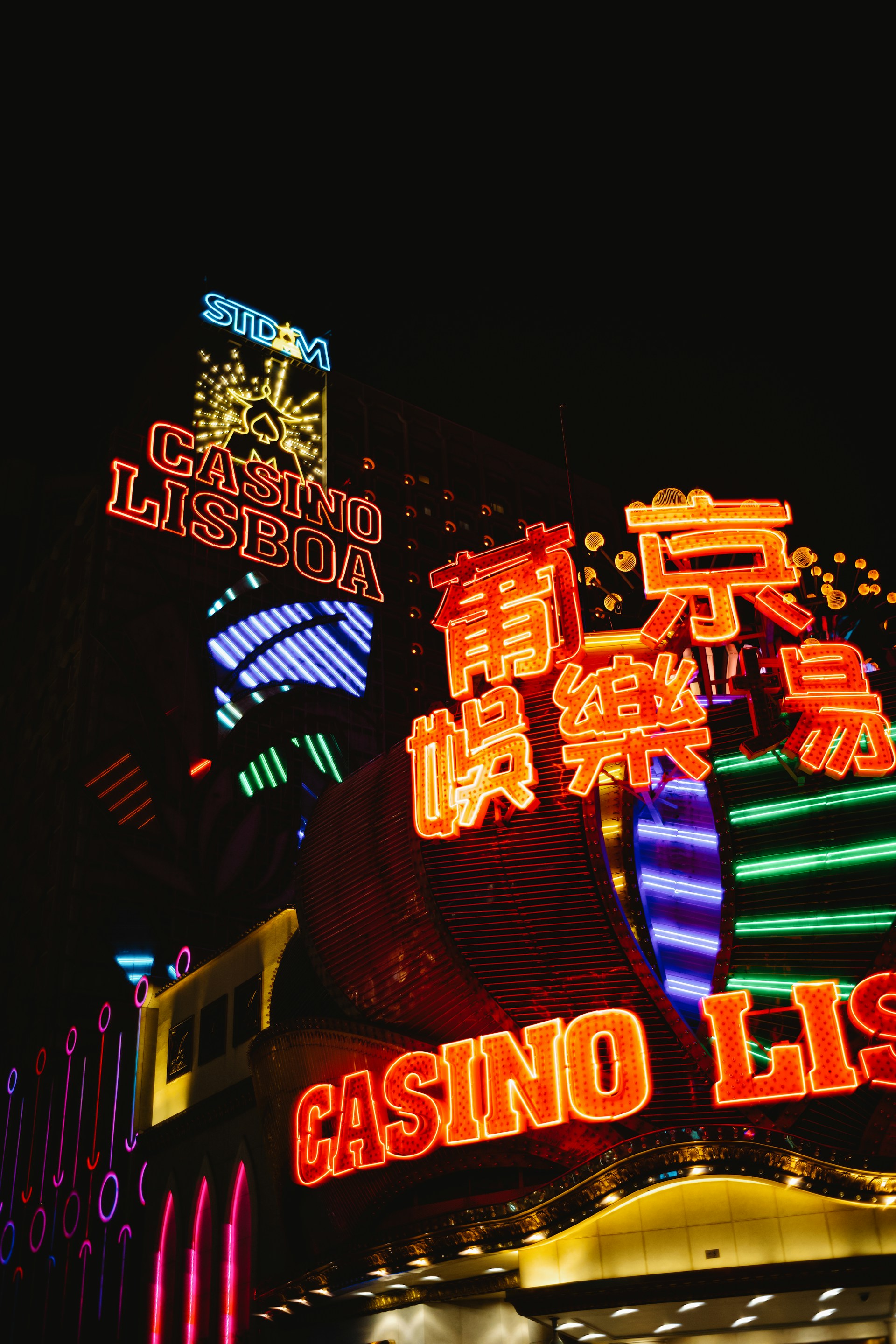 a casino sign lit up at night with neon lights