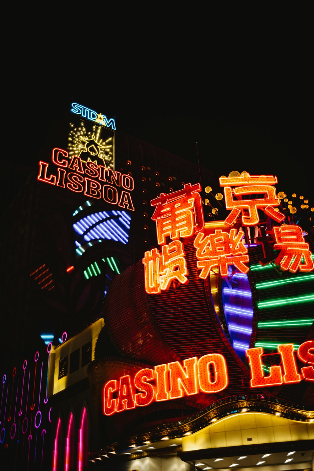 a casino sign lit up at night with neon lights