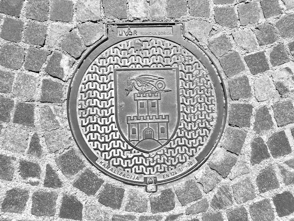 a black and white photo of a manhole cover