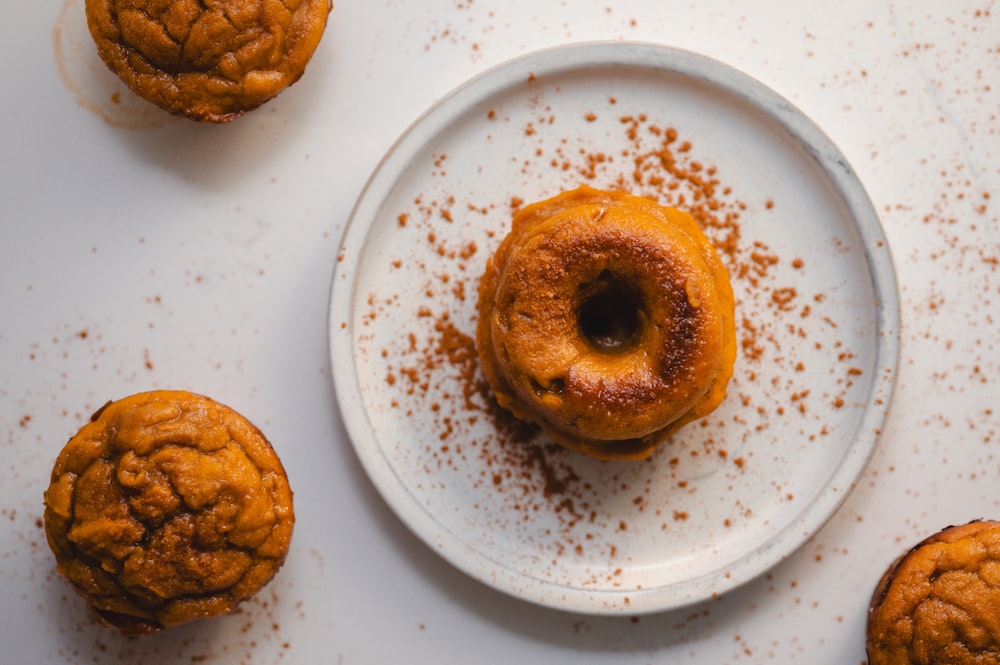 a white plate topped with a donut covered in powdered sugar