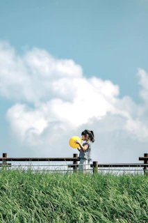 Young girl pitching with fierce determination during a sunny softball game