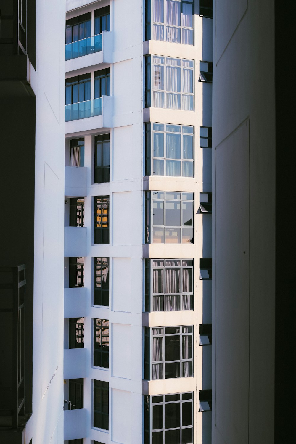 a tall white building sitting next to a tall white building