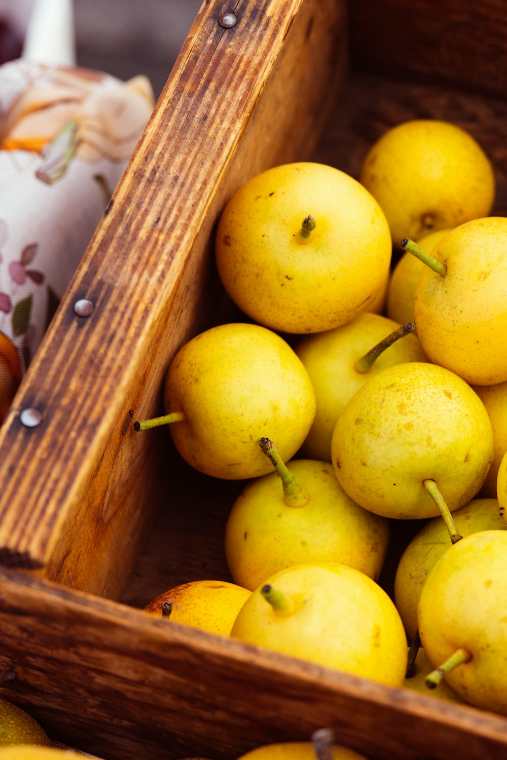 a wooden crate filled with lots of yellow fruit