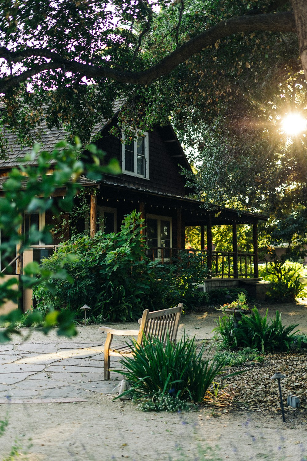 a wooden bench sitting in front of a house