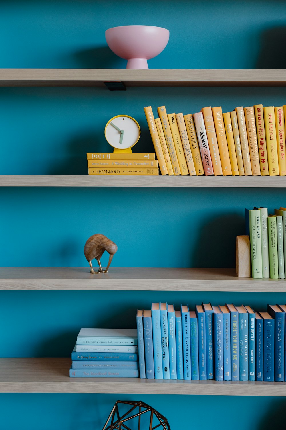 a bookshelf filled with books and a clock