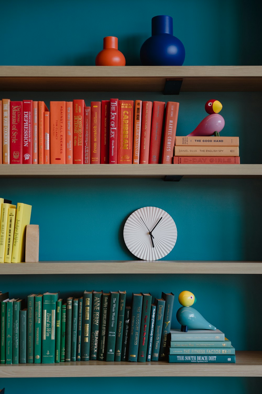 a bookshelf filled with books and a clock