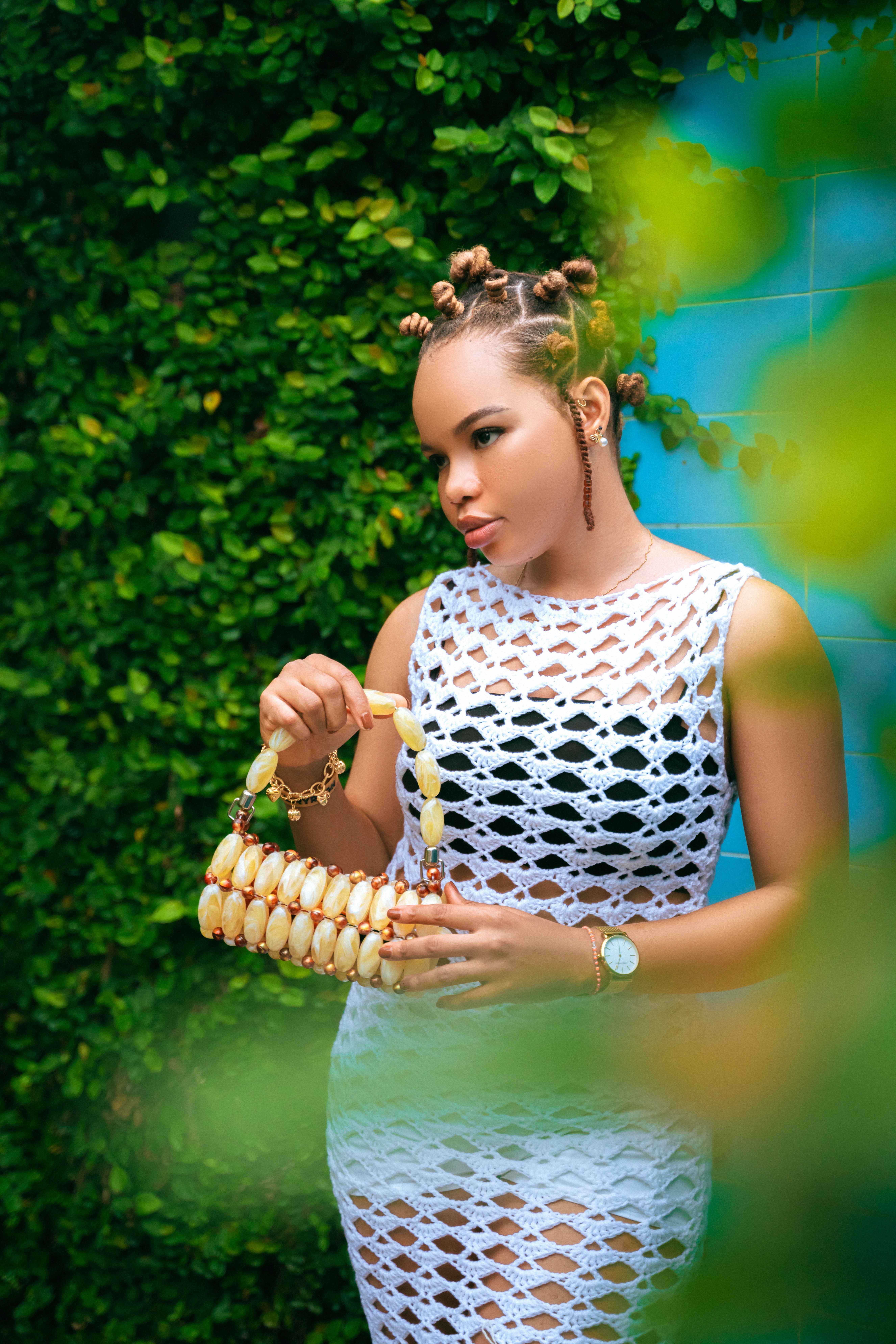 a woman in a white dress holding a corn cob
