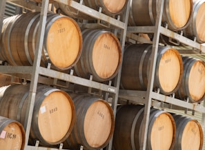 Large barrels of vinegar and vinegar substitutes stored in a clean industrial facility.
