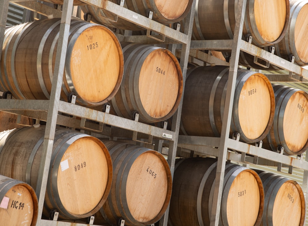 a bunch of wooden barrels stacked on top of each other