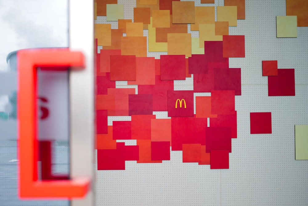 a mcdonald's sign in front of a colorful wall