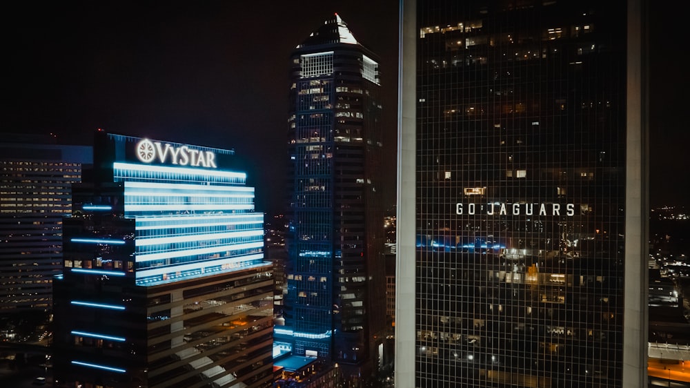 a view of a city at night from the top of a skyscraper